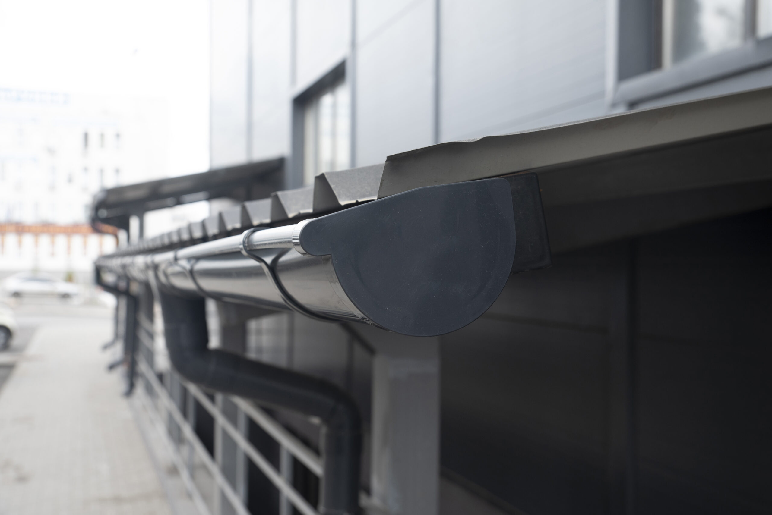 Close-up graphite colored plastic gutter system, gutter plug